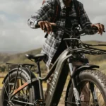 A man riding on the back of a bicycle.