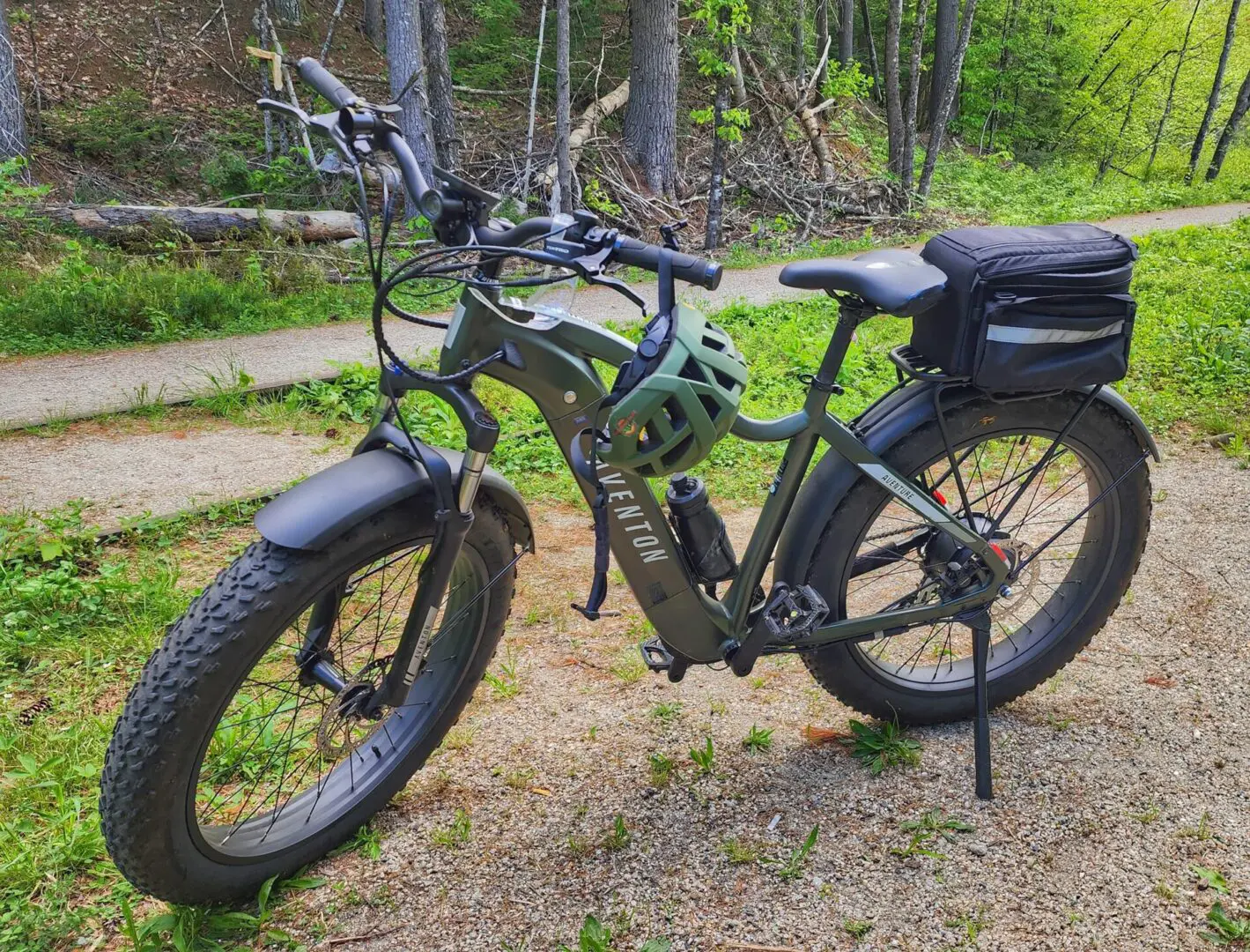 A bicycle parked on the ground in front of some trees